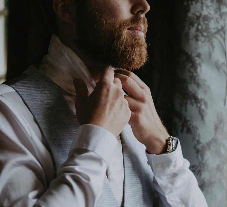 Groom gets ready for country house wedding