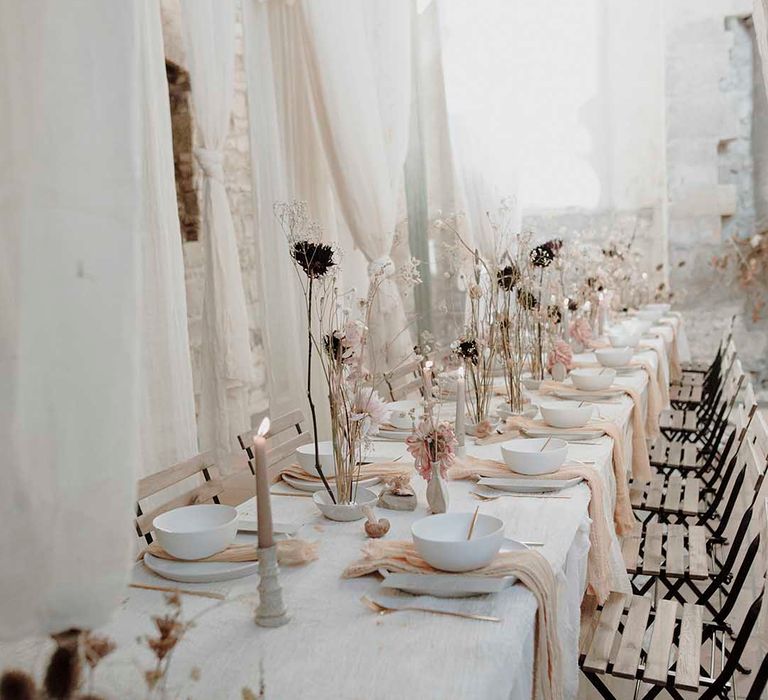 romantic wedding reception decor with drapes dried flowers and candles 