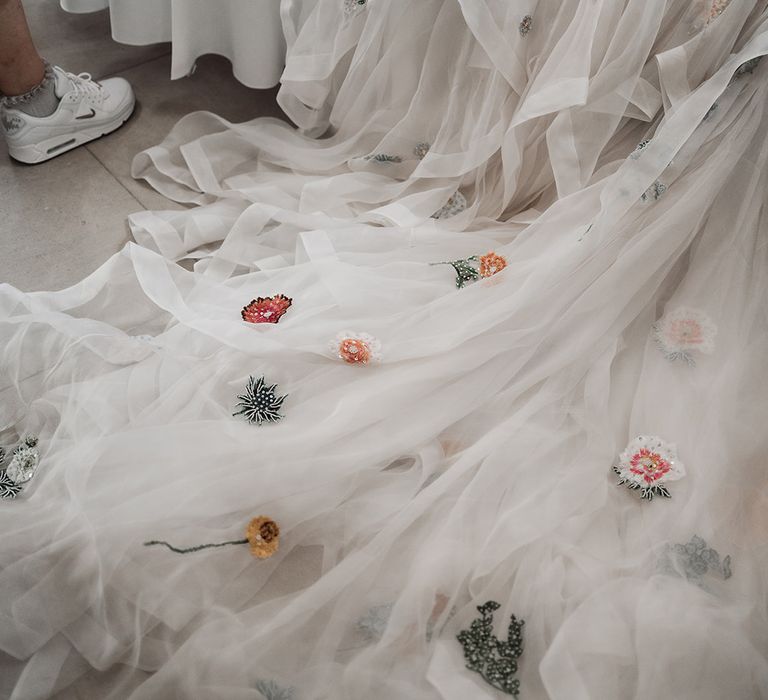 Mesh train of Victoria Sanders wedding dress with embroidered flowers 