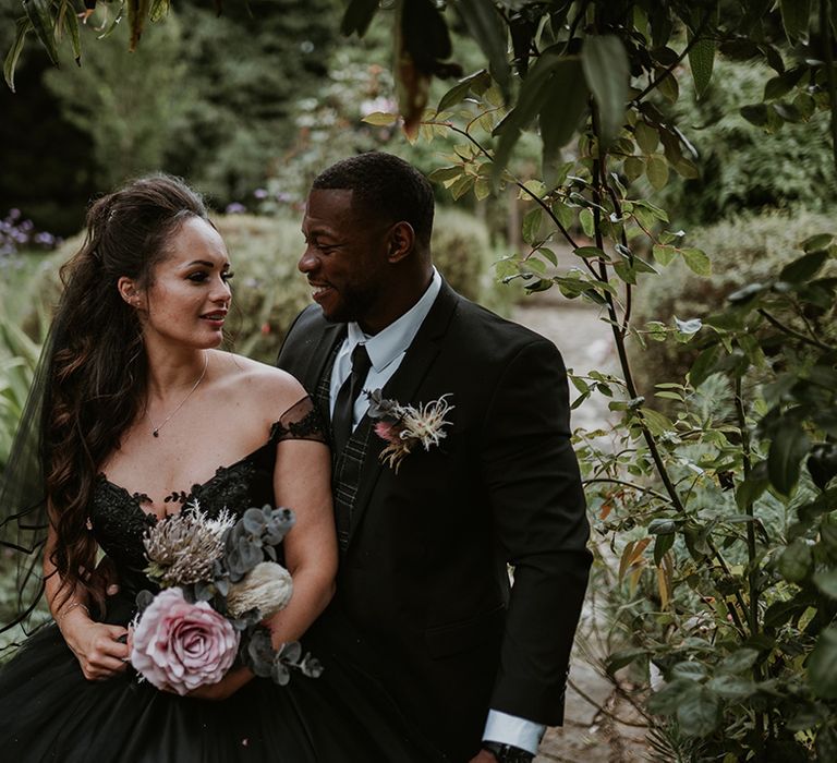 Bride & groom look lovingly at one another 