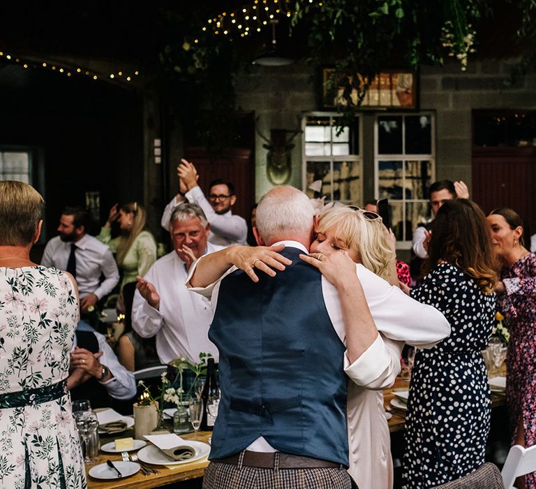 Wedding guests hug and applaud the newlyweds at Errol Park wedding venue 