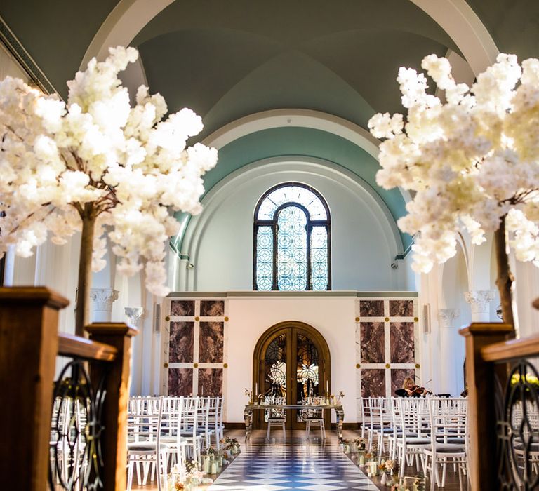 Wedding ceremony room with stained glass windows and white flowers