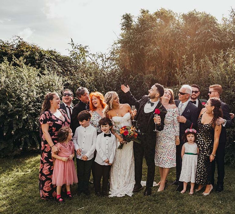 Bride and groom with their wedding party on sunny day