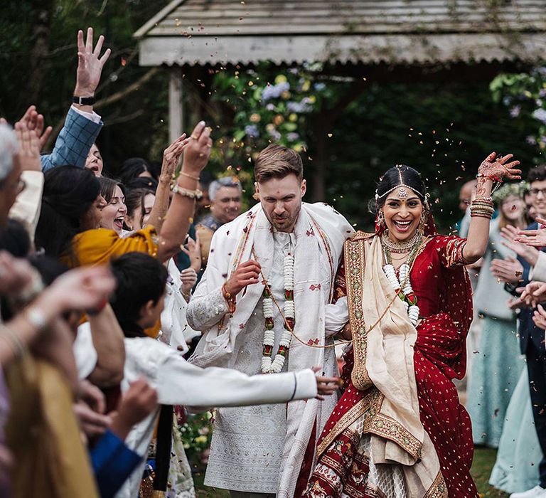 Bride and groom have confetti exit form their second wedding ceremony at Pennard House