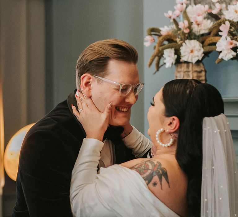 Bride wears pearl hoop earrings as she marries her groom at the Old Marylebone Town Hall for city wedding