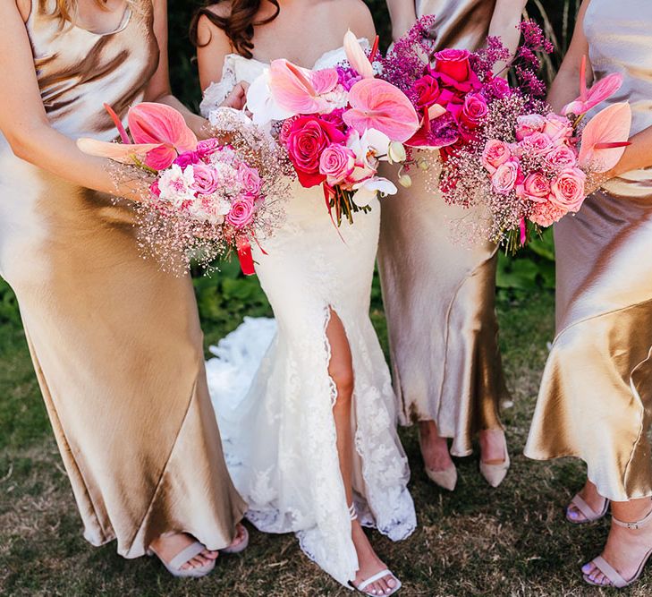 Bright pink floral bouquets filled with anthuriums and roses 