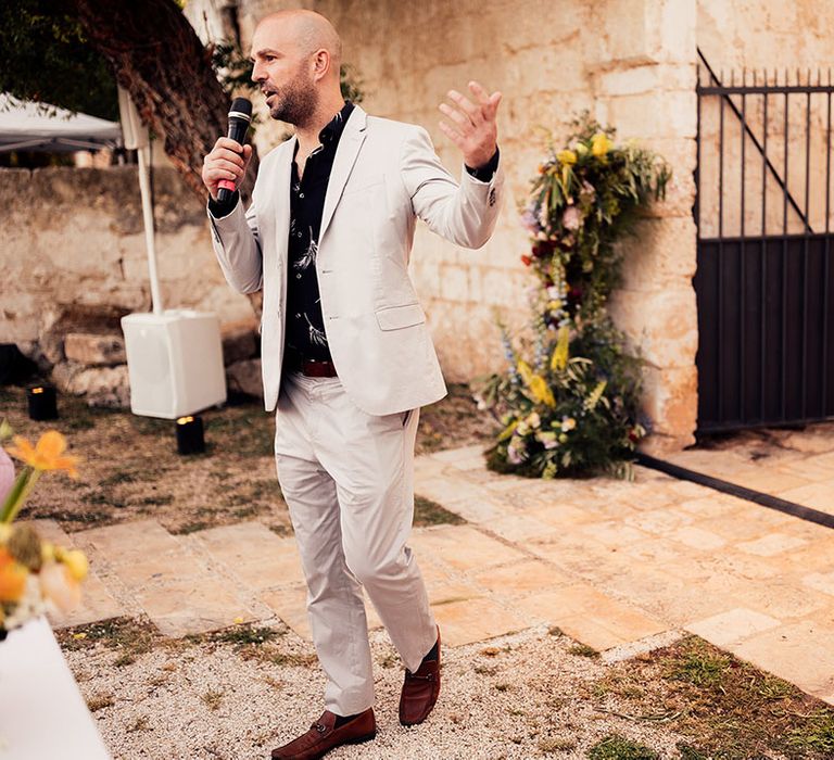 Wedding guest delivers a speech at the rustic Italian destination wedding 