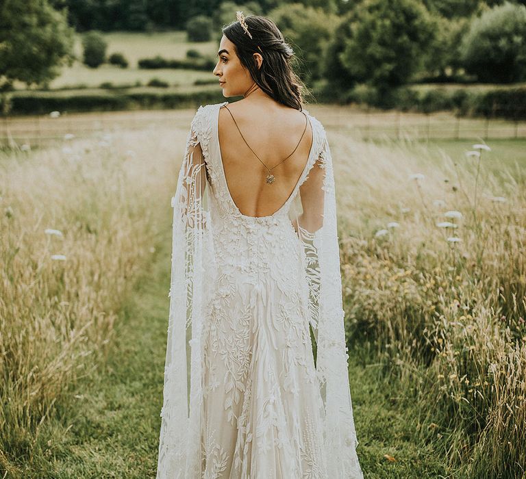 Boho bride in an open back lace gown for her wedding day 