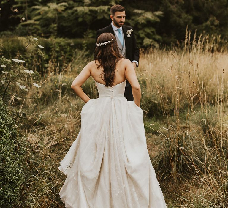 Bride in a strapless Phillipa Lepley wedding dress with half up half down style wedding hair 