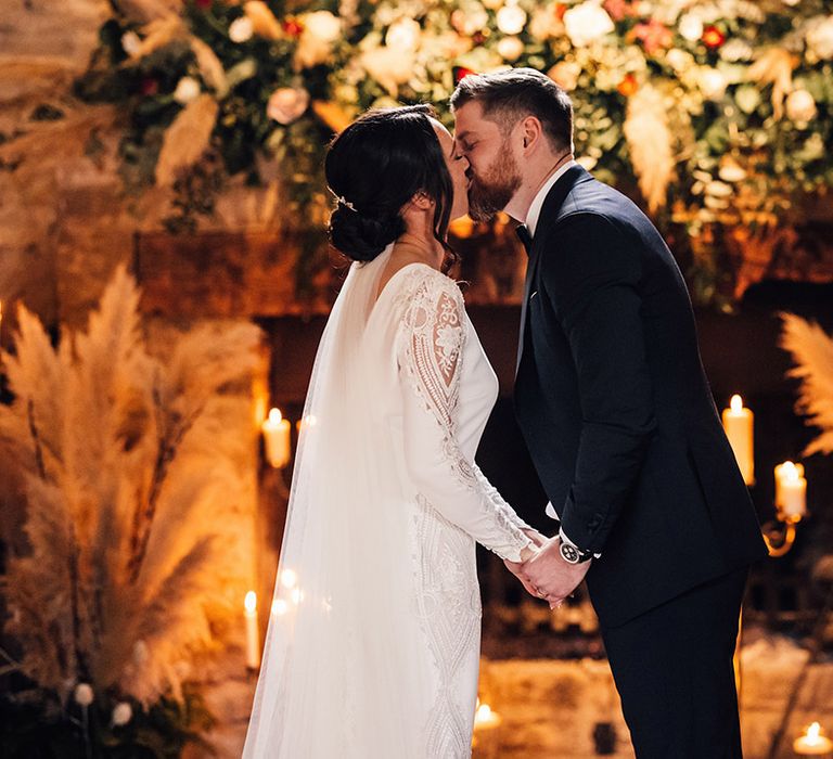 The bride and groom share their first kiss as a married couple 