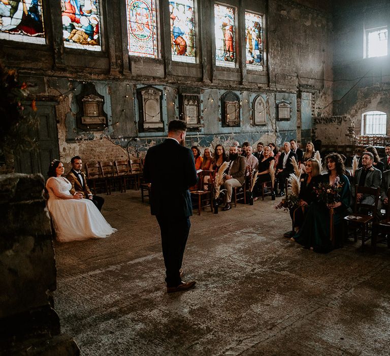 Guest does wedding reading at industrial wedding venue in London