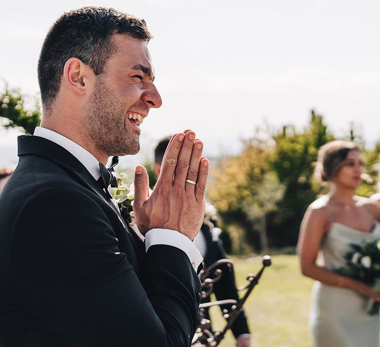 Groom sees his bride for the first time during outdoor wedding ceremony