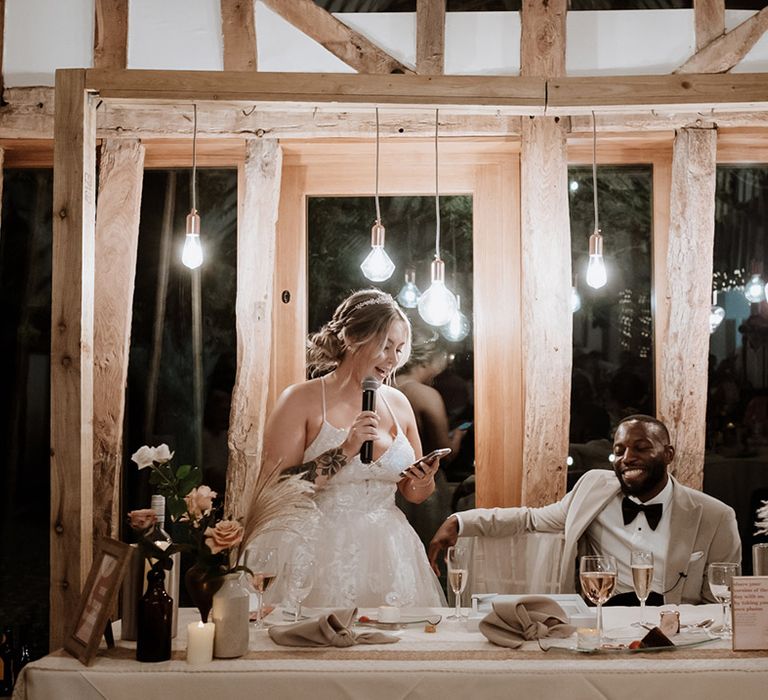 The bride stands up at the wedding breakfast to read out her bridal speech 