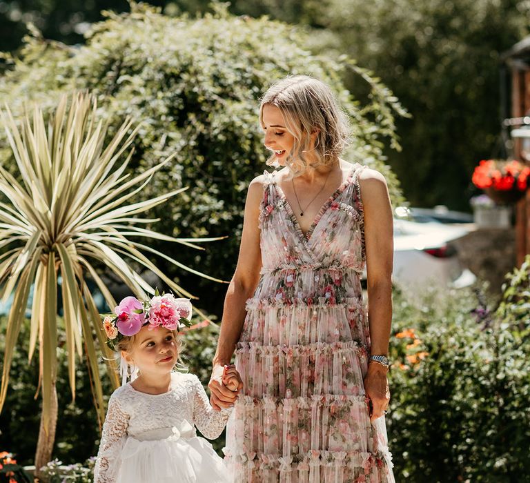 Bridesmaid and flower girl walking at the wedding during summer 