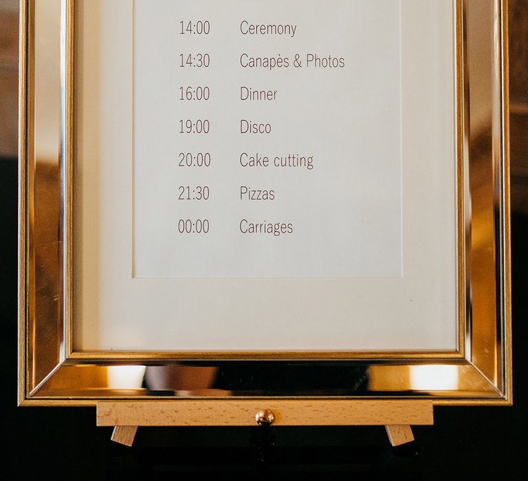 Gold framed wedding order of the day sign for country house wedding at Coombe Lodge 