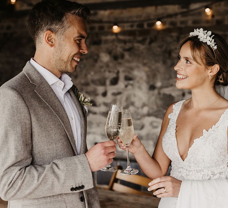 The bride and groom drink champagne together alone to celebrate their wedding day 