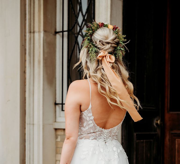 Bride with half up half down delicate princess wedding hair with flower crown accessory for boho style autumn wedding 