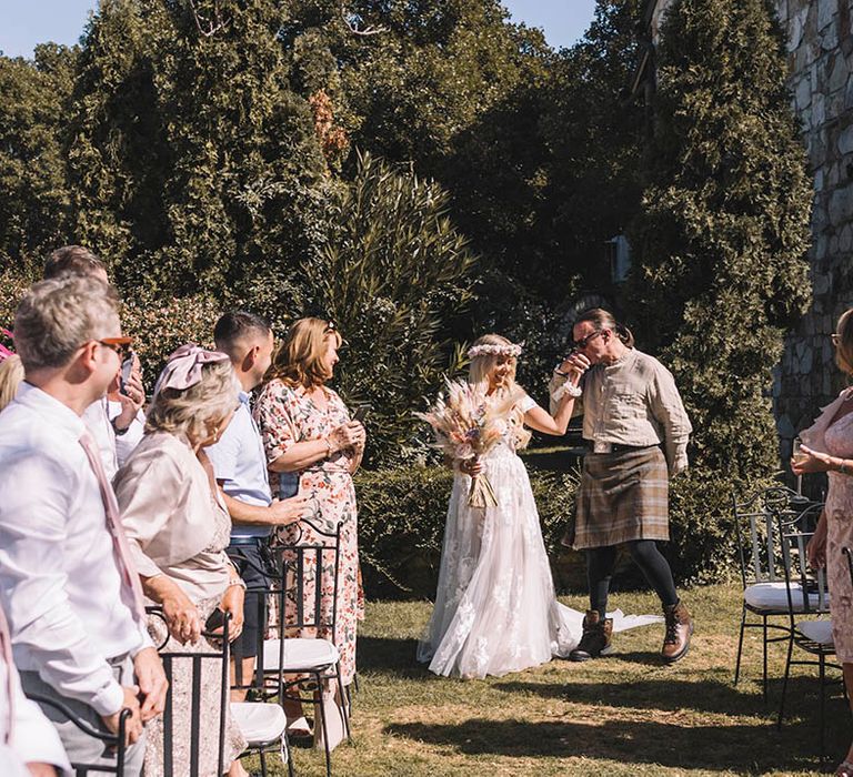 Father of the bride walks the bride to the aisle so she can walk the rest on her own at Croatia wedding ceremony 