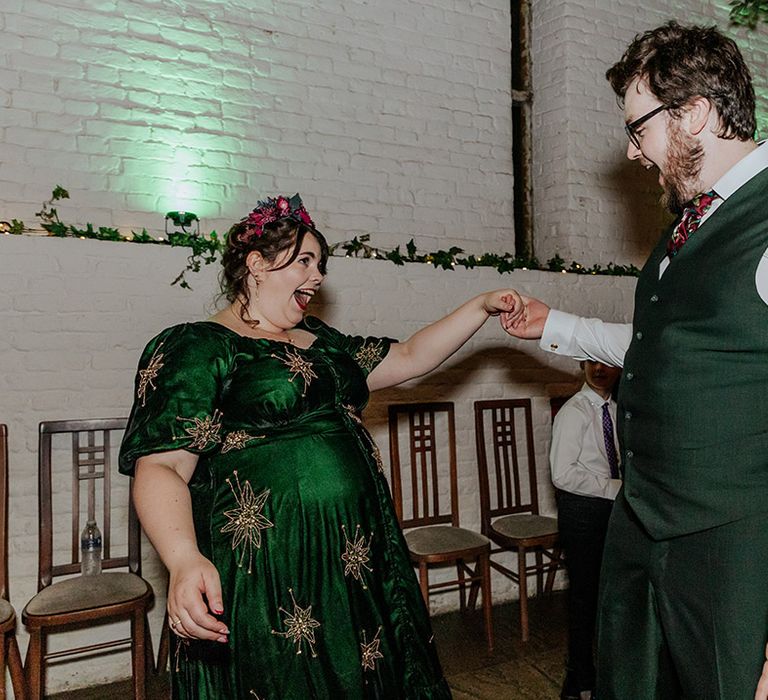 Bride in green and gold star wedding reception dress dancing with the groom 