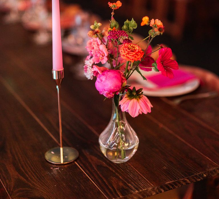 Pink theme wedding table decoraitons with pink candles and flowers 