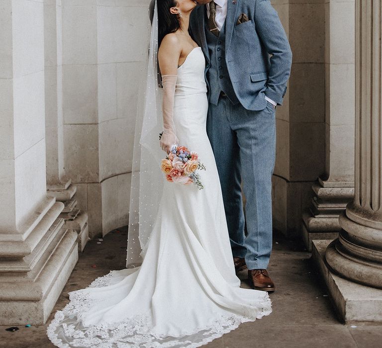 The bride and groom kiss each other at Old Marylebone Town Hall