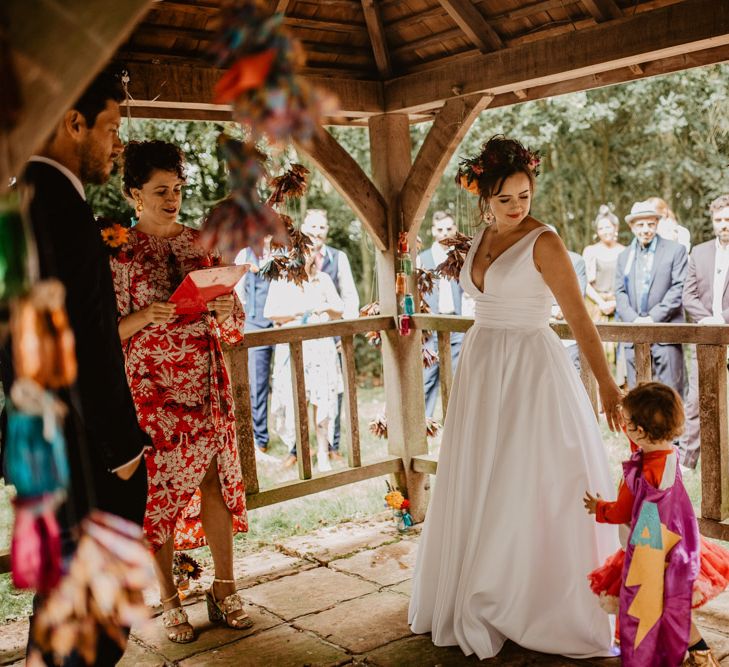 Rainbow decor at outdoor wedding ceremony 