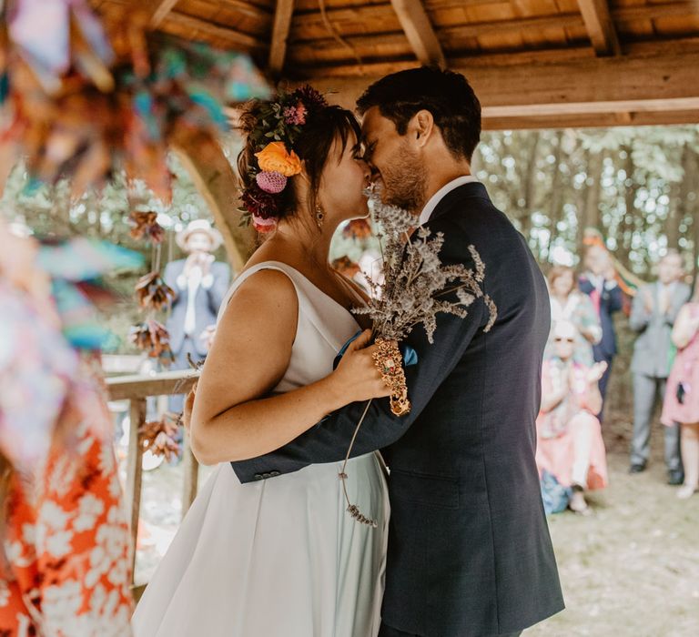 bride and groom kissing at outdoor humanist ceremony 