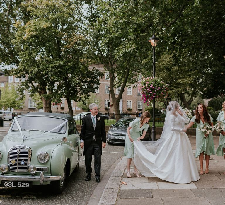 London wedding bride getting ready to walk into church with bridesmaids 