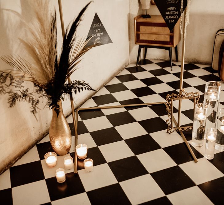 Black & white tiled floor with floral display with pampas grass