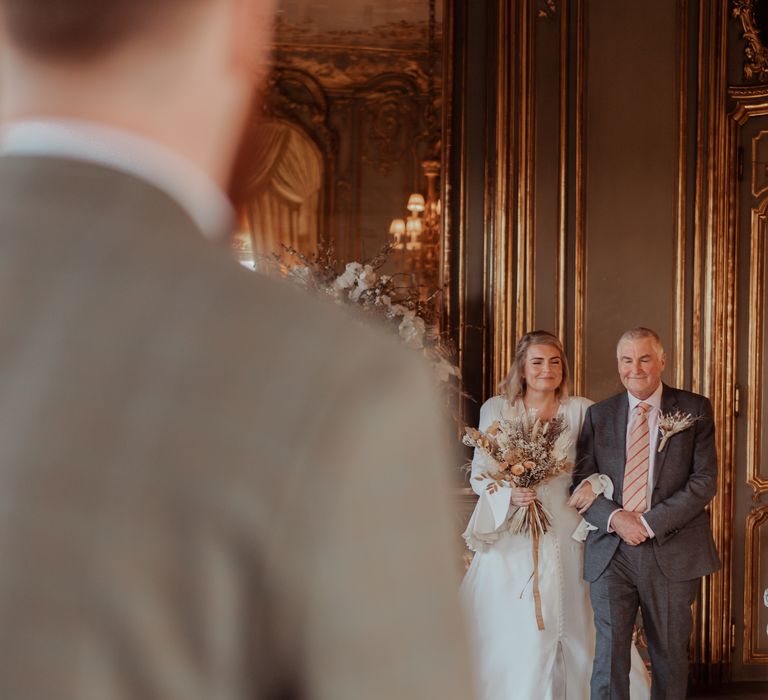 Bride walks down the aisle with her father