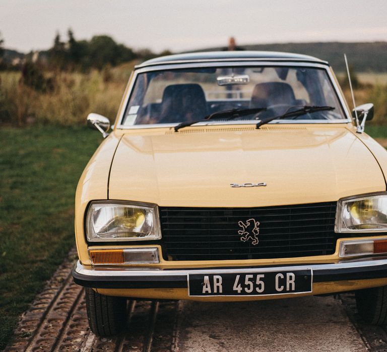 Yellow vintage Pequot wedding car 