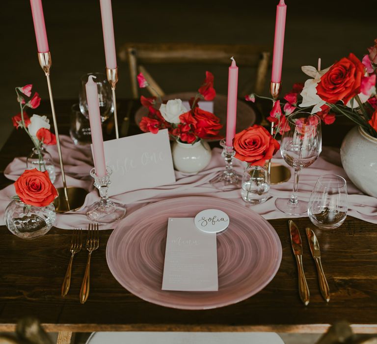 Coral inspired tablescape with stationery, golden candlestick holders and cutlery