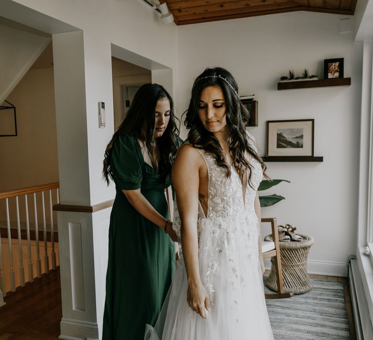 Bride has help getting ready on the morning of her wedding