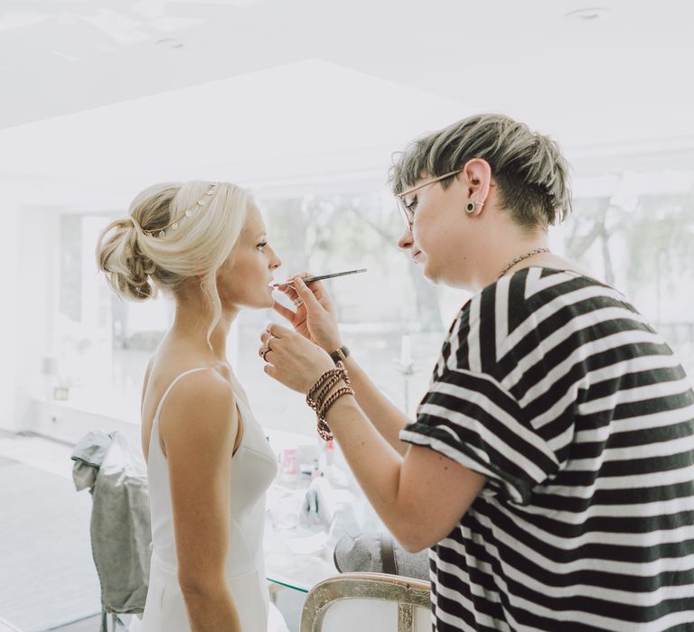 Bride has her makeup done on the morning of her wedding day