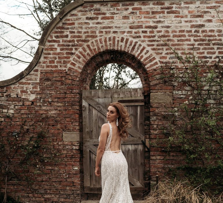 Bride in a intricate wedding dress with low back design