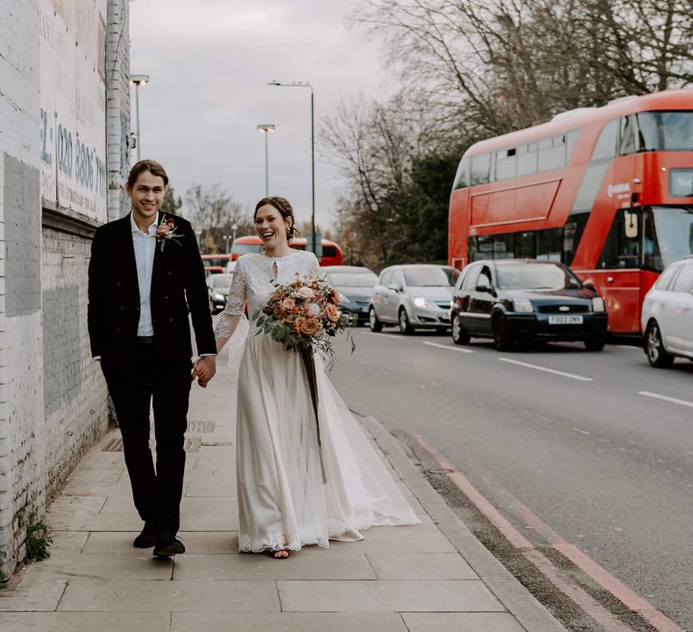 Bride and groom on busy London street on their wedding day