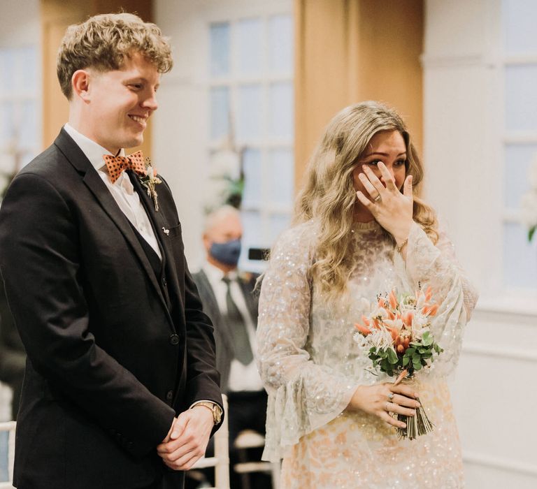 Bride crying with joy stood next to her new husband at registry office wedding