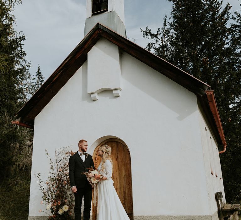 Bride and groom standing outside the Chalet Pia Luxury Chalet at their Dolomites wedding