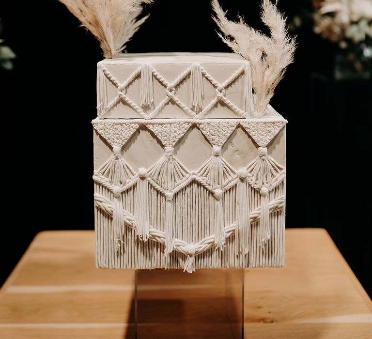 Illusion wedding cake in white with Macrame style frosting and pampas grass decor