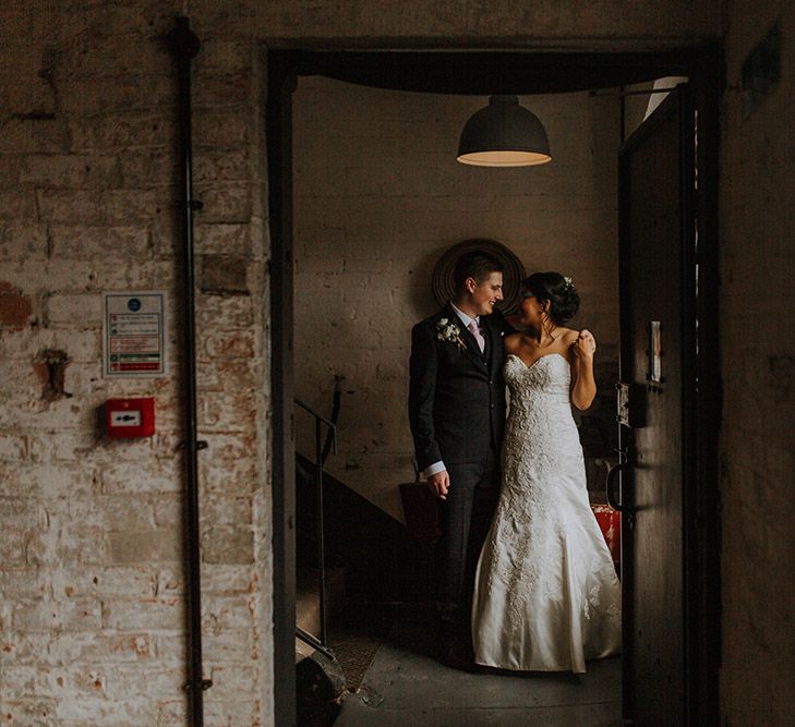 A bride and grooms hug for wedding portrait.