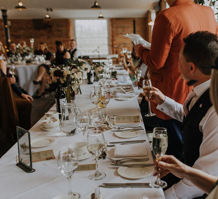 Guests listen to wedding speeches.