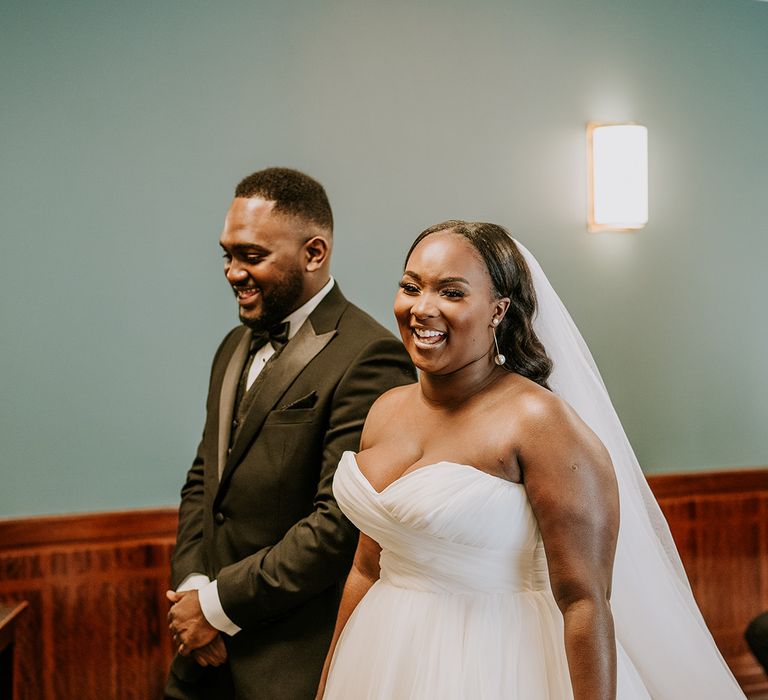 Bride & groom leave wedding ceremony with one another hand in hand 