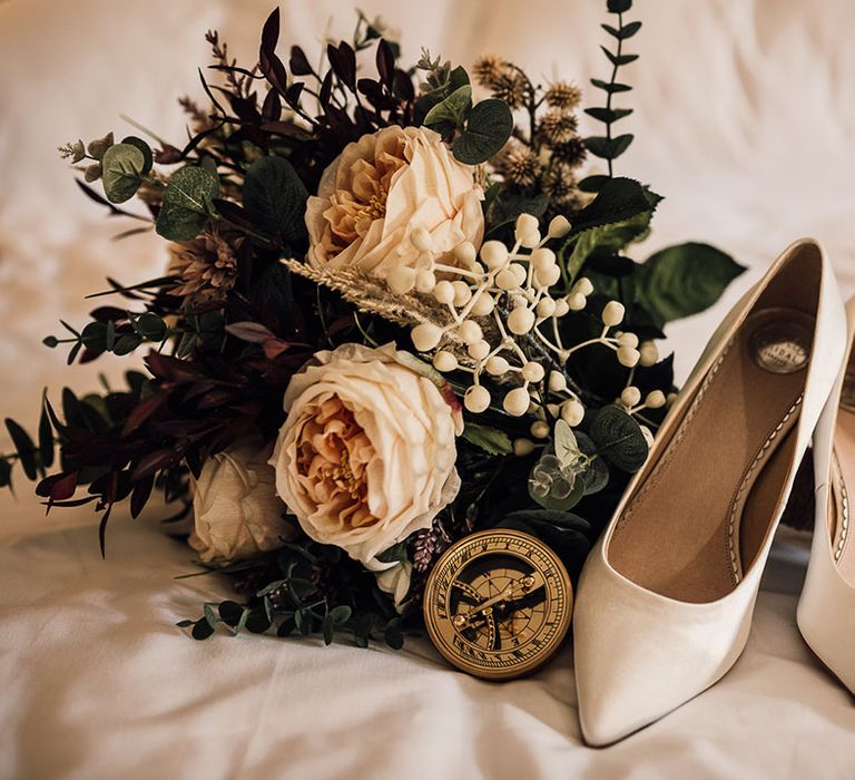 Cream wedding shoes for bride with artificial wedding bouquet