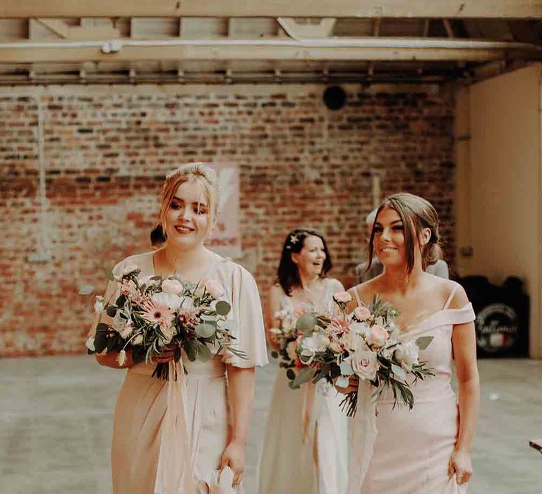 Blush bridesmaid dresses and bouquets