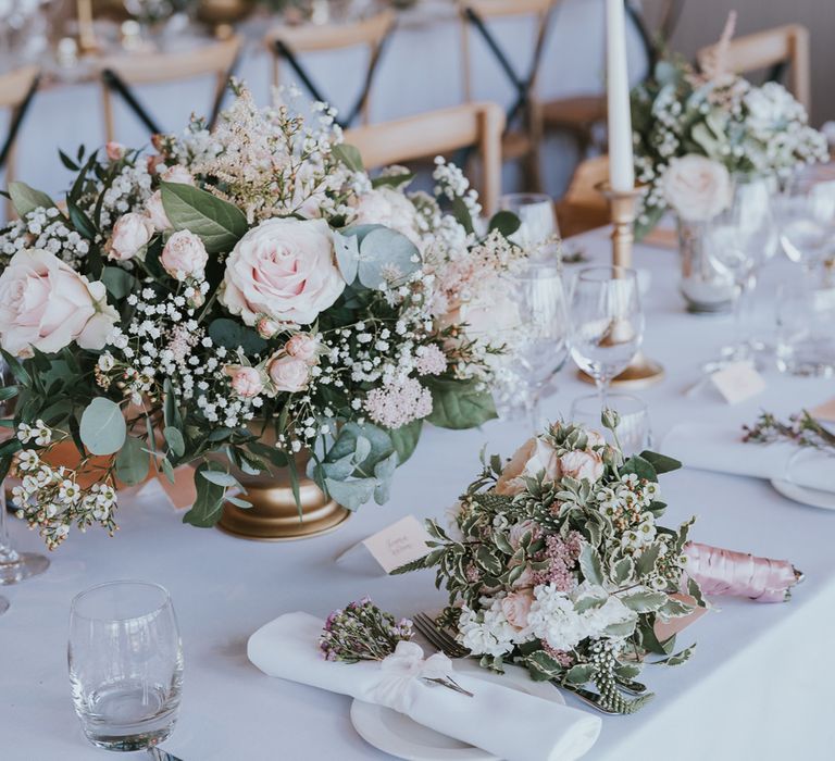 White wedding tablescape with white, blush pink florals and foliage, candles and white napkins for summer wedding at Primrose Hill Farm