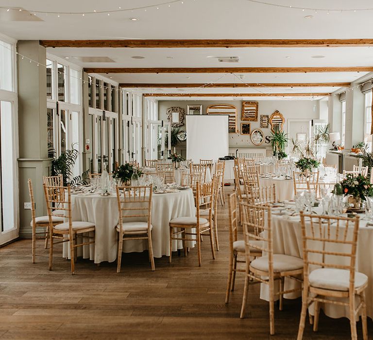 Classic reception venue complete with sage green accent colour and floral bouquets 