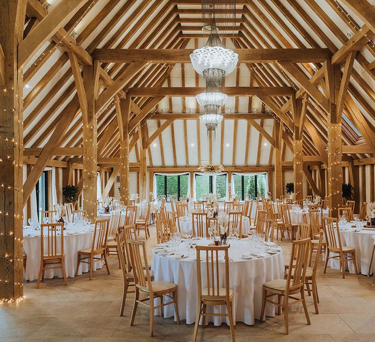 Barn wedding venue with fairy lights and wooden beams