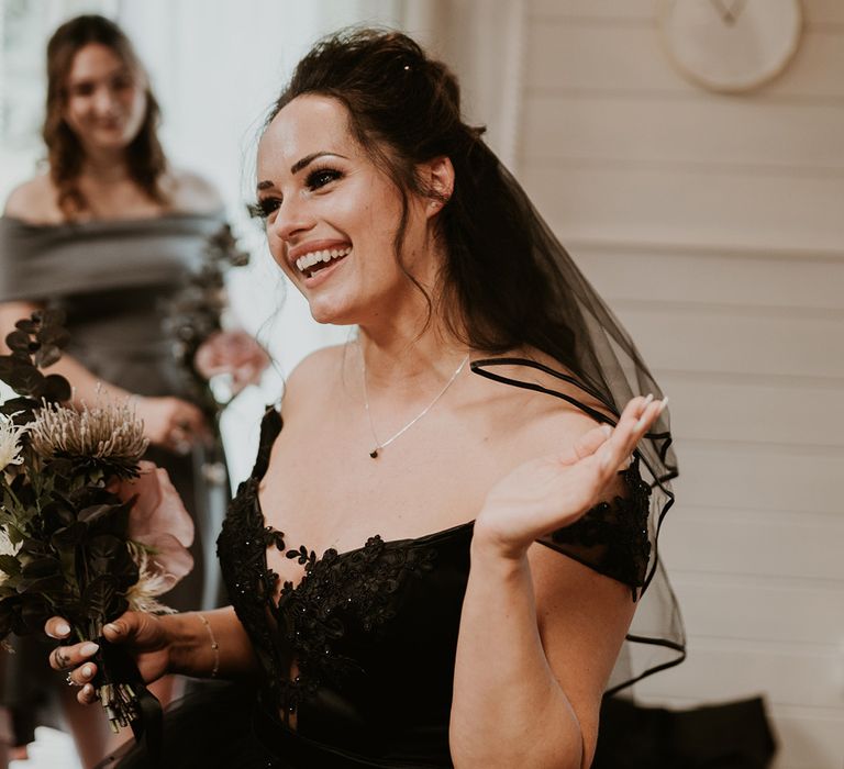 Bride wears homemade strapless black wedding dress and black veil 