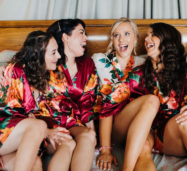 Bride and bridesmaids in floral silk dressing gowns getting ready for the wedding