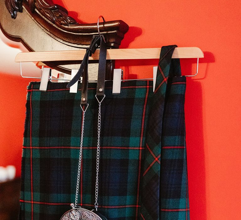 Tartan kilts hang on the morning of wedding day